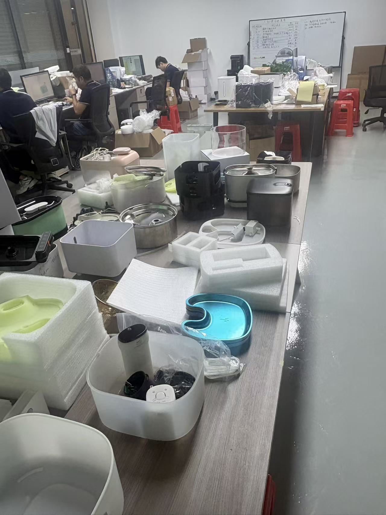 Fountain components and sample units on a workbench.