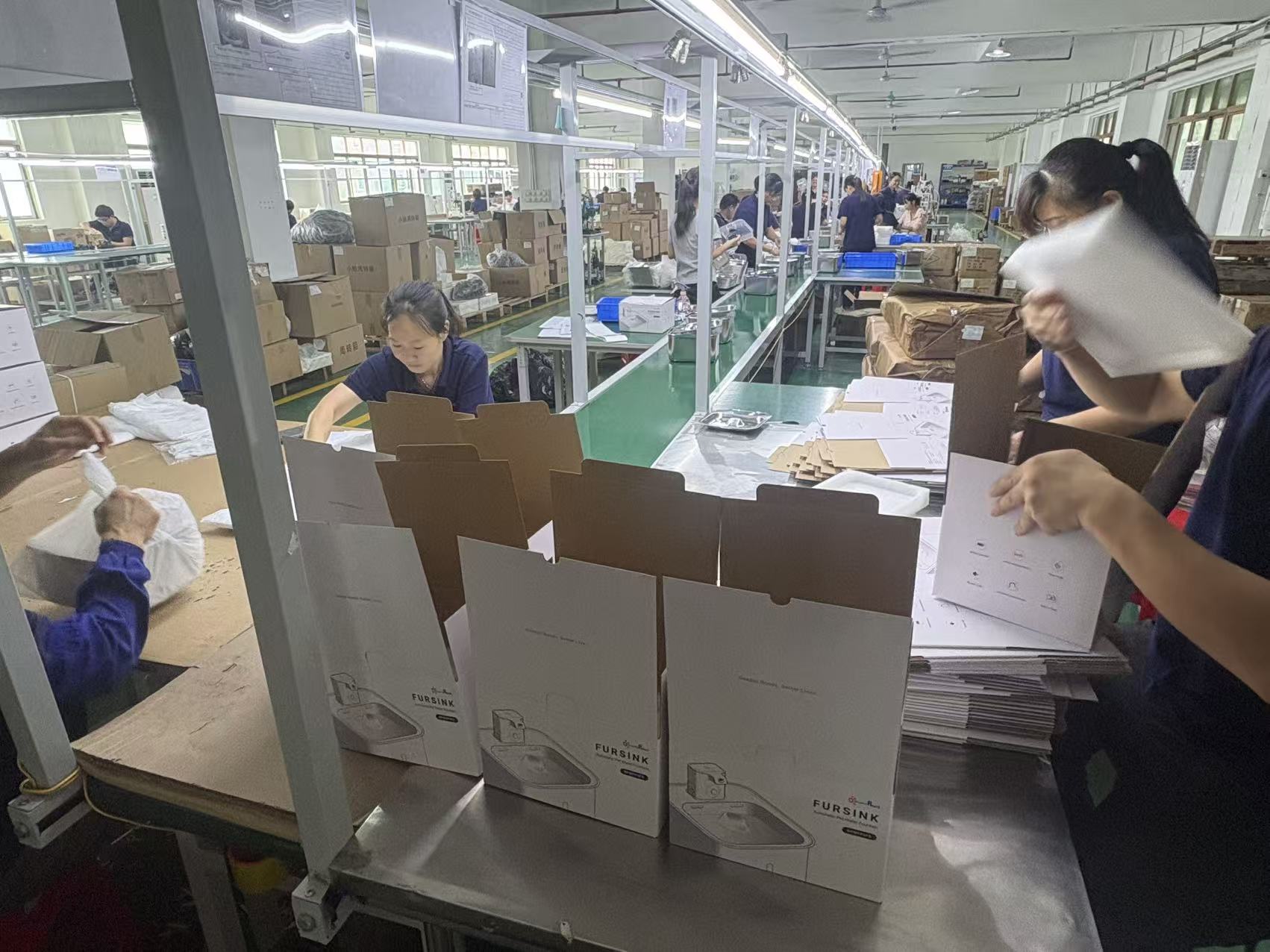 Units and cartons at a packing station.