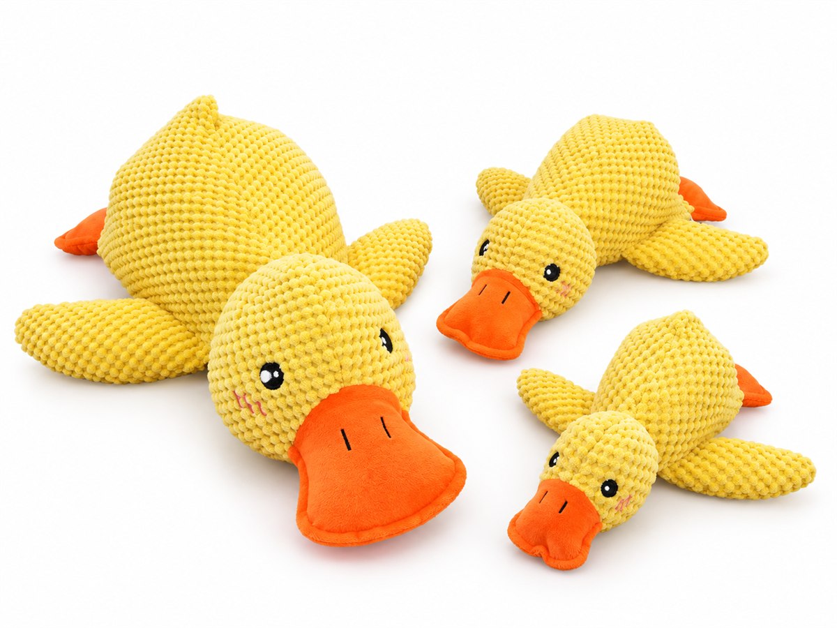 Yellow plush dog toys on a white background